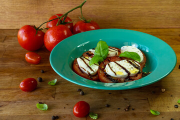 Caprese salad with mozzarella cheese, tomatoes and basil