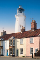 The lighthouse behind and towering above houses in the seaside town of Southwold in Suffolk, uk.