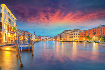 Stunning sunset and evening cityscape of Venice with famous Canal Grande and Rialto Bridge