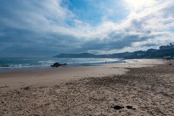 beach at sunrise in the spanish town of comillas, cantabria.