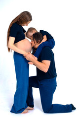 Beautiful pregnant woman with her family on white background