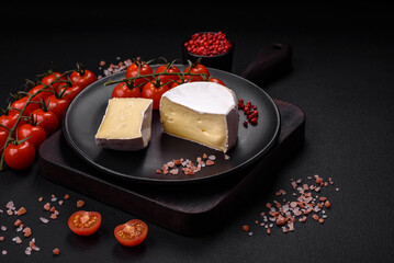 Delicious fresh brie cheese in the form of a mini head with cherry tomatoes