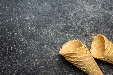 Empty wafer cone. Sweet ice cream cornet on kitchen table. Top view.