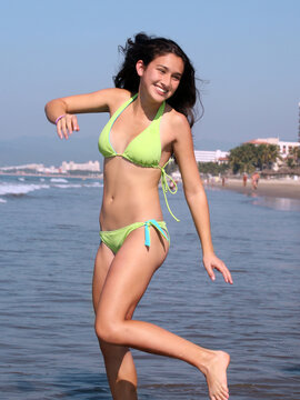 A teenage girl is having good time on the beach