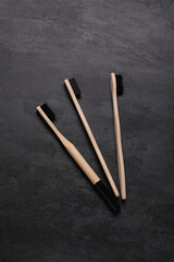 Bamboo toothbrushes on grunge black background