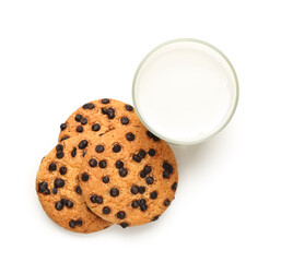 Tasty cookies with chocolate chips and glass of milk on white background