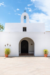 Fototapeta na wymiar Church of El Pilar de La Mola, on the island of Formentera. A typical white church with simple forms and Mediterranean character. Balearic Islands, Spain.