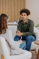 young man in consultation with psychologist is taking care of mental health. Psychotherapy for...