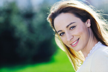 Obraz premium happy young beautiful woman face closeup and portrait outdoor at sunny day