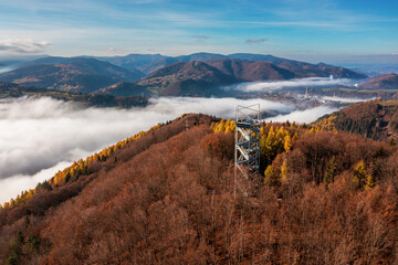 Aerial Drone Shot: Sightseeing Tower in Brezno, Autumn Scenery with Misty Morning and Cloud...