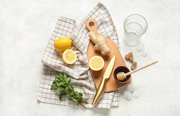 Wooden board with ingredients for preparing lemonade on grunge white background