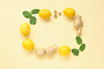 Frame made of ripe lemons with mint and ginger on pale yellow background