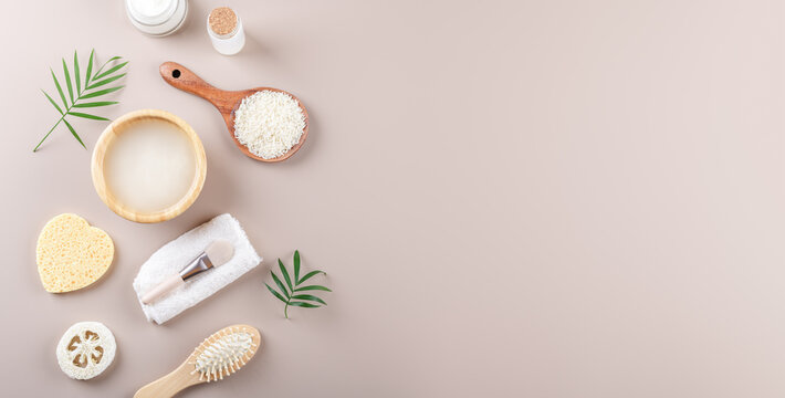 Homemade cosmetic rice water with ingredients on beige background, healthy beauty hair treatment ingredients for homemade comsetics, beauty recipe for home spa, natural skincare preparation, banner
