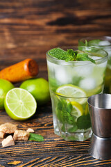Glass of cold mojito on wooden background