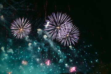 Blue white and green fireworks celebration in the sky. Very cheap firework over the city, Blue white and green