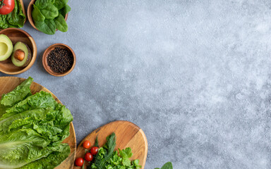 Lettuce, tomato, parsley, avocado and onion on a gray background. The concept of vegetarian food, healthy lifestyle and nutrition