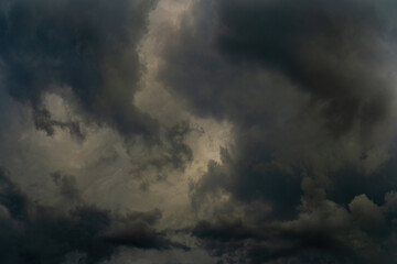 dramatic stormy sky with fluffy dark cumulus clouds