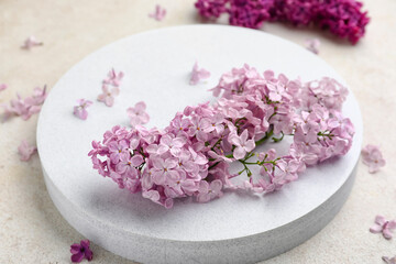 Obraz na płótnie Canvas Stand with beautiful fragrant lilac flowers on grunge white background