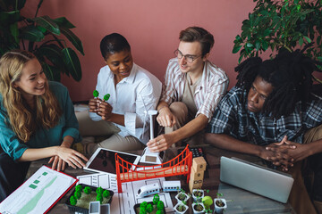 International diverse group of students working on modern urban architecture project with renewable...