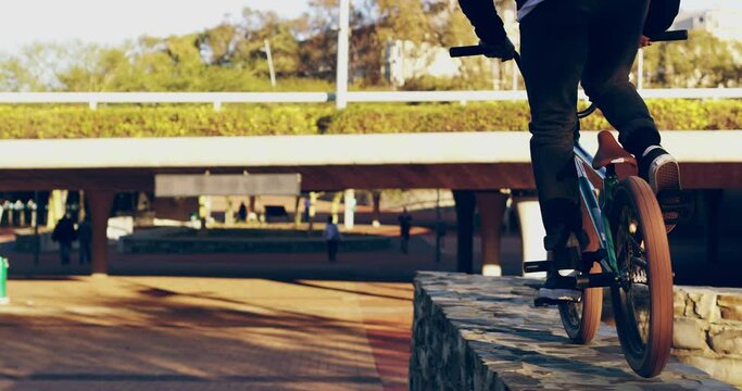 Sports, action and bmx with man and bike for energy, stunts and cycling tricks in city park. Fitness, health and jump with athlete riding on bicycle for extreme exercise, danger and speed in summer