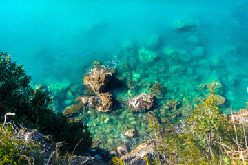 Naklejka na ściany i meble Beautiful crystal clear water in the sea of Lerici, Liguria, Italy