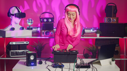 Cheerful musician working as dj in night club mixing sounds at professional mixer console, enjoying dancing and performing for fans. Performer creating musical performance with electronic music