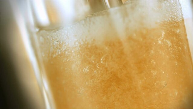 Refreshing craft IPA beer poured into a glass in stunning slow-motion 4K. Witness the artistry of brewery craftsmanship, capturing the aromatic pour and golden hues. 