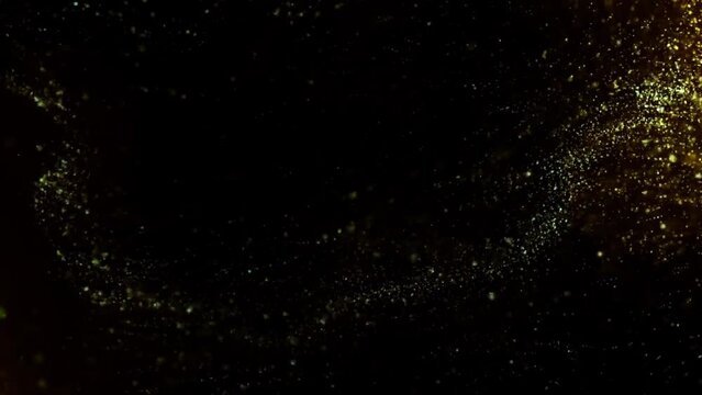 Gold dust particles fly in slow motion in the air lingering slowly. Dust Particles Background Bokeh Lights Background on Black Background 4k Footage Snow Particles Background.