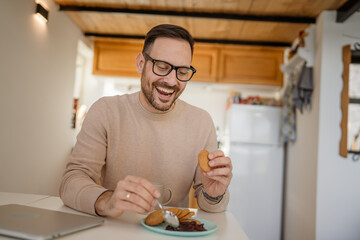 Fototapeta na wymiar Adult caucasian Man Enjoy Breakfast at Home with Jam and Biscuit