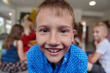 Portrait photo of a smiling boy in a preschool institution having fun