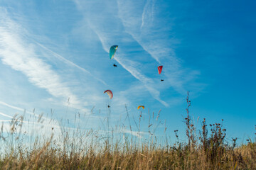 Paragliders on Mount Csobanc on a summer afternoon. Summer adrenaline-boosting sports