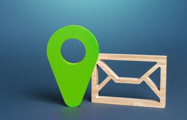 Envelope symbol and geolocation sign in green. Sending or receiving information, messages, or...