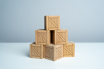 Stack of stacked wooden crates, pyramid of boxes. Order for shipment. Production and freight of goods. Increase in imports and exports, economic recovery.