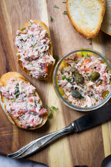 Salmon rillettes, mousse, pate and toasts on wooden background