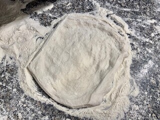 Flat and neutral pizza base. Artisan flour and bakery. Raw white pizza on marble counter. Neutral background image.