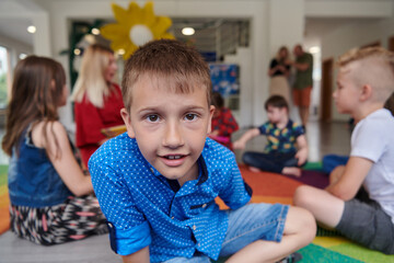 Portrait photo of a smiling boy in a preschool institution having fun