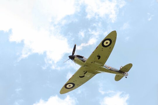 Cambridge, United Kingdom - September 12 2015 - A Supermarine Spitfire World War 2 figher plane flies over the skies of Cambridge during the Dragon Boat Festival