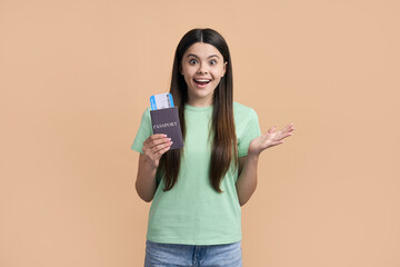 Cheerful teen girl going for weekend getaway, smiling at camera, holding passport and flight ticket