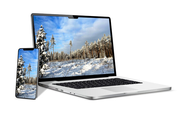 Laptop and phone with winter landscape wallpaper