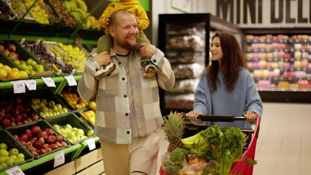 Step into the world of fresh produce with this happy family as they pick fruits in a store. From the smiles on their faces to the quality of the produce, everything about this video celebrates a