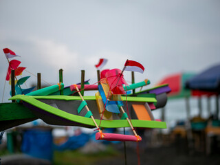 A miniature Indonesian flag in a toy ship, shallow focus