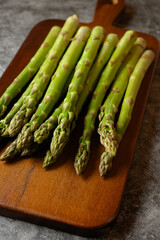 Green asparagus on a wooden board.