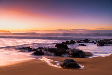 Fototapeta na wymiar Sunrise and Waves - Surf's up at the seaside