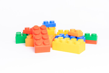pile plastic toy blocks on white background