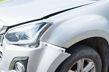 Fototapeta premium The front of a white car was damaged in a road accident.