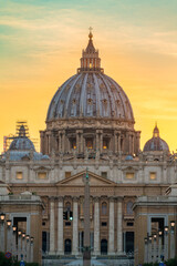 Fototapeta na wymiar St Peter's basilica dome at sunset in Vatican