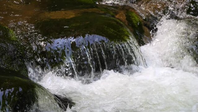 Seething picturesque clean mountain river in slow motion. The strength and beauty of a mountain stream