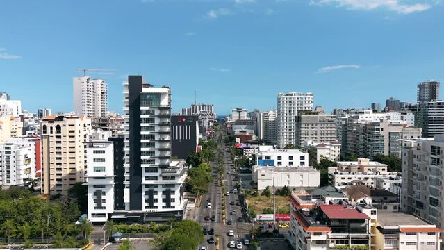 Aerial static view of the city center of Santo Domingo. Skyscrapers and office buildings in downtown. Traffic jam on Abraham Lincoln street at rush hour 