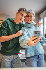 teenager boy young man and mature woman mother and son take selfie photos self portraits at home