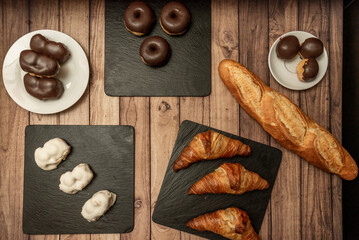 A slate plate with simple chocolate candies, butter croissants